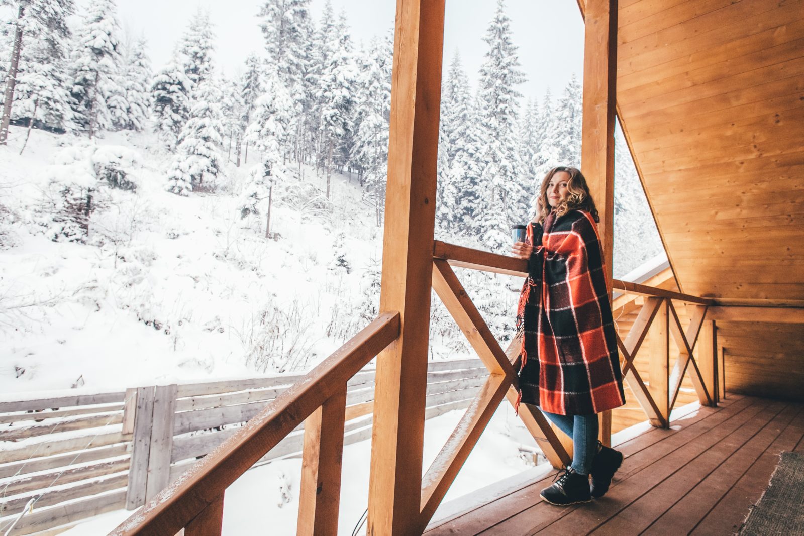 woman standing on pole barn porch in winter