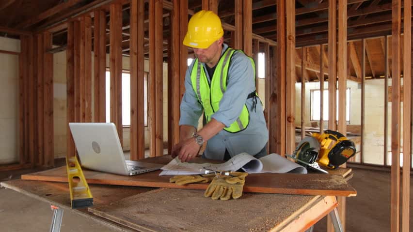 construction worker using laptop computer